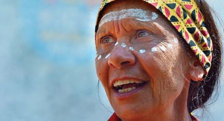 Indigenous woman in headscarf and white face paint