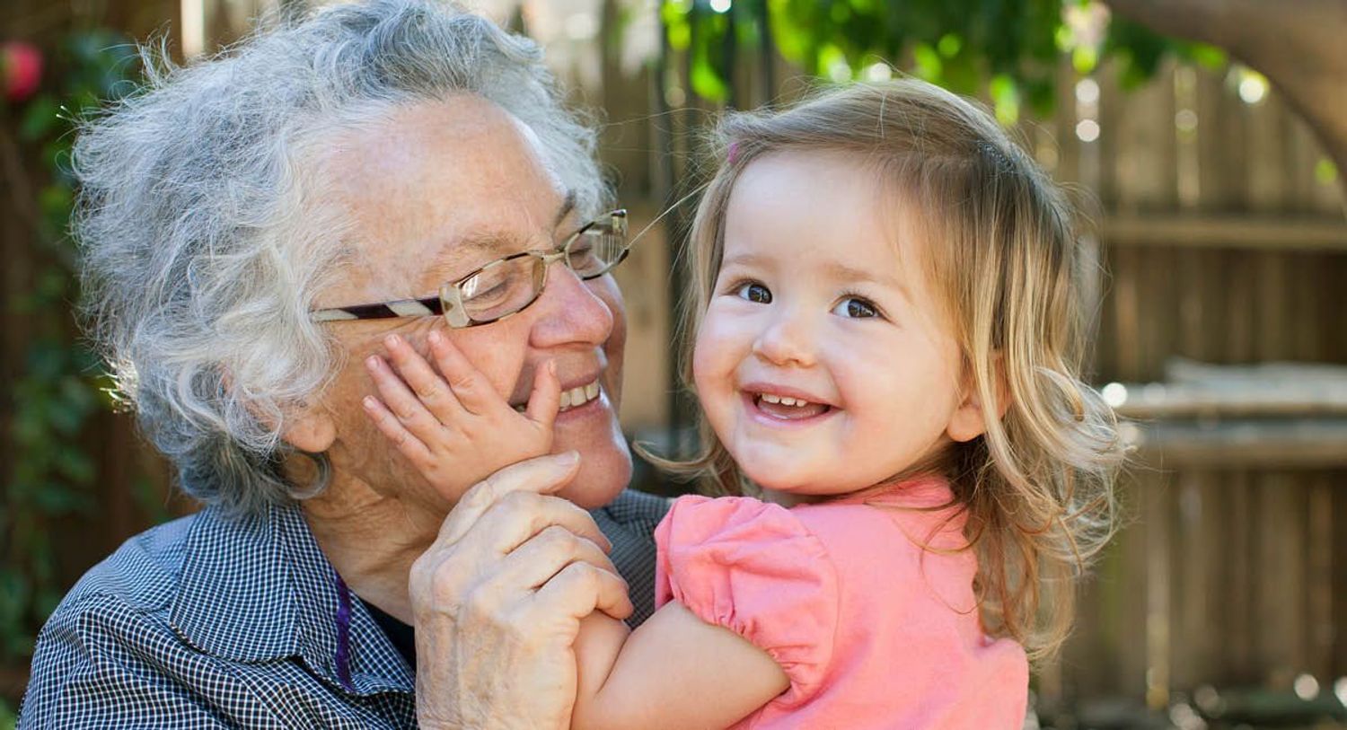 Grandmother and granddaughter smiling and showing affection for each other