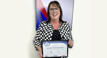 A smiling ADA Deputy CEO Eithne Irving holds the 2023 Smile Award