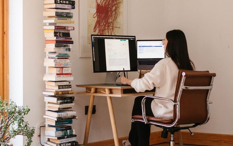 Woman at a desk working on a laptop.