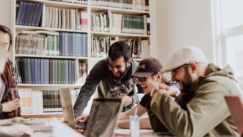 Group working on laptops in a library