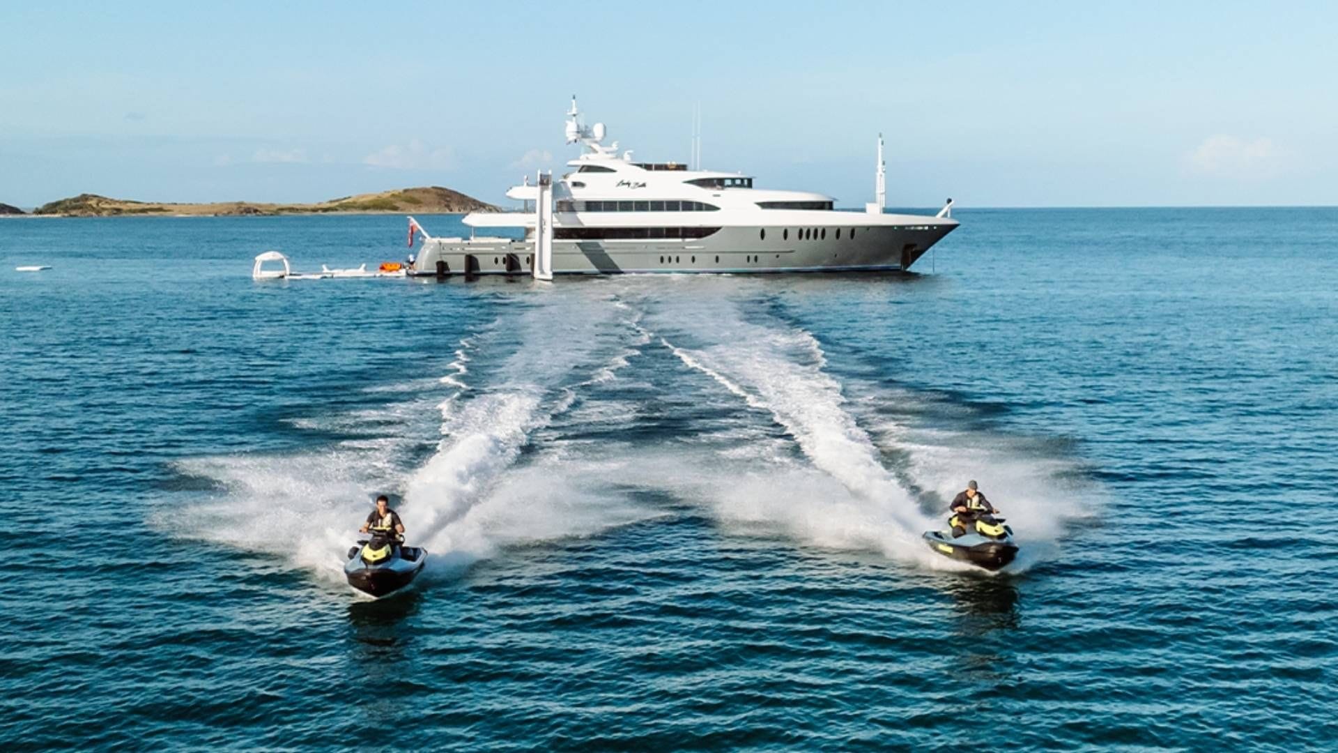 jets ski sailing away yacht