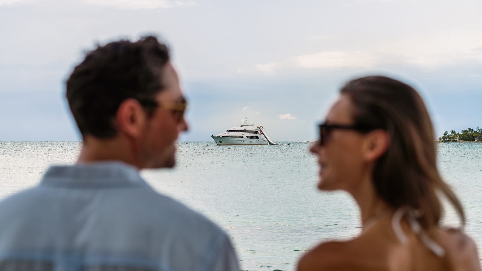 couple with yacht in the background 