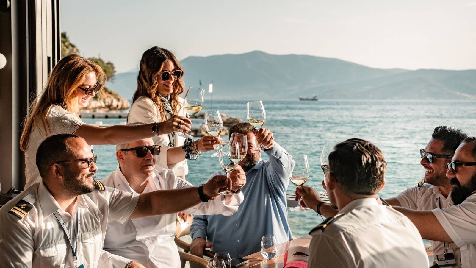 a group of people having wine onboard an iyc yacht