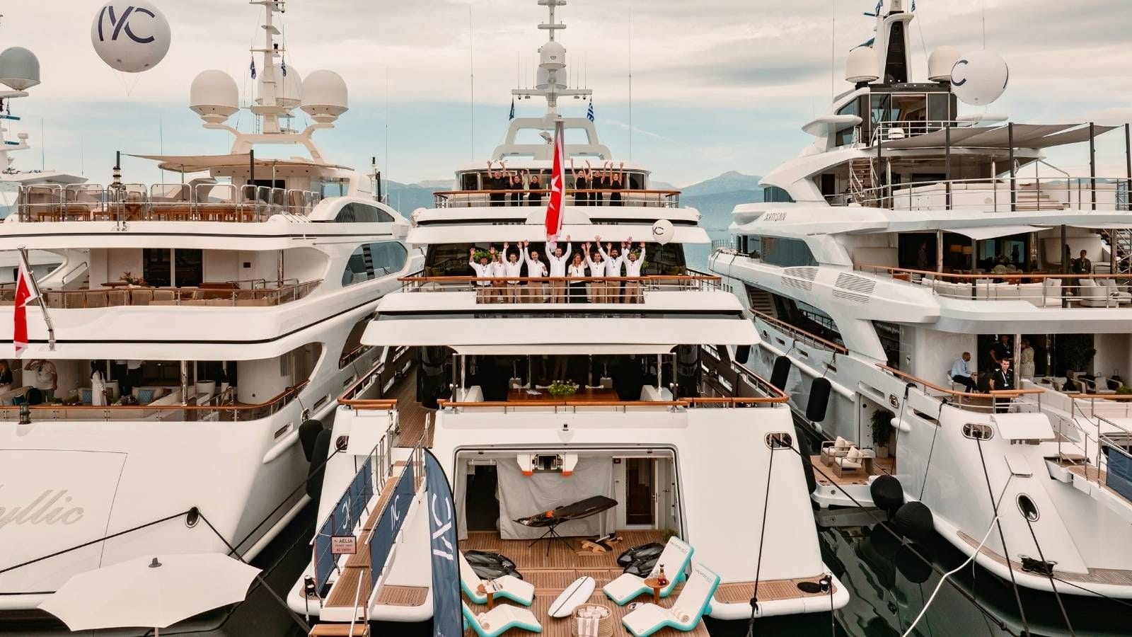 the crew of an iyc yacht waving at a drone at the 10th medys in greece