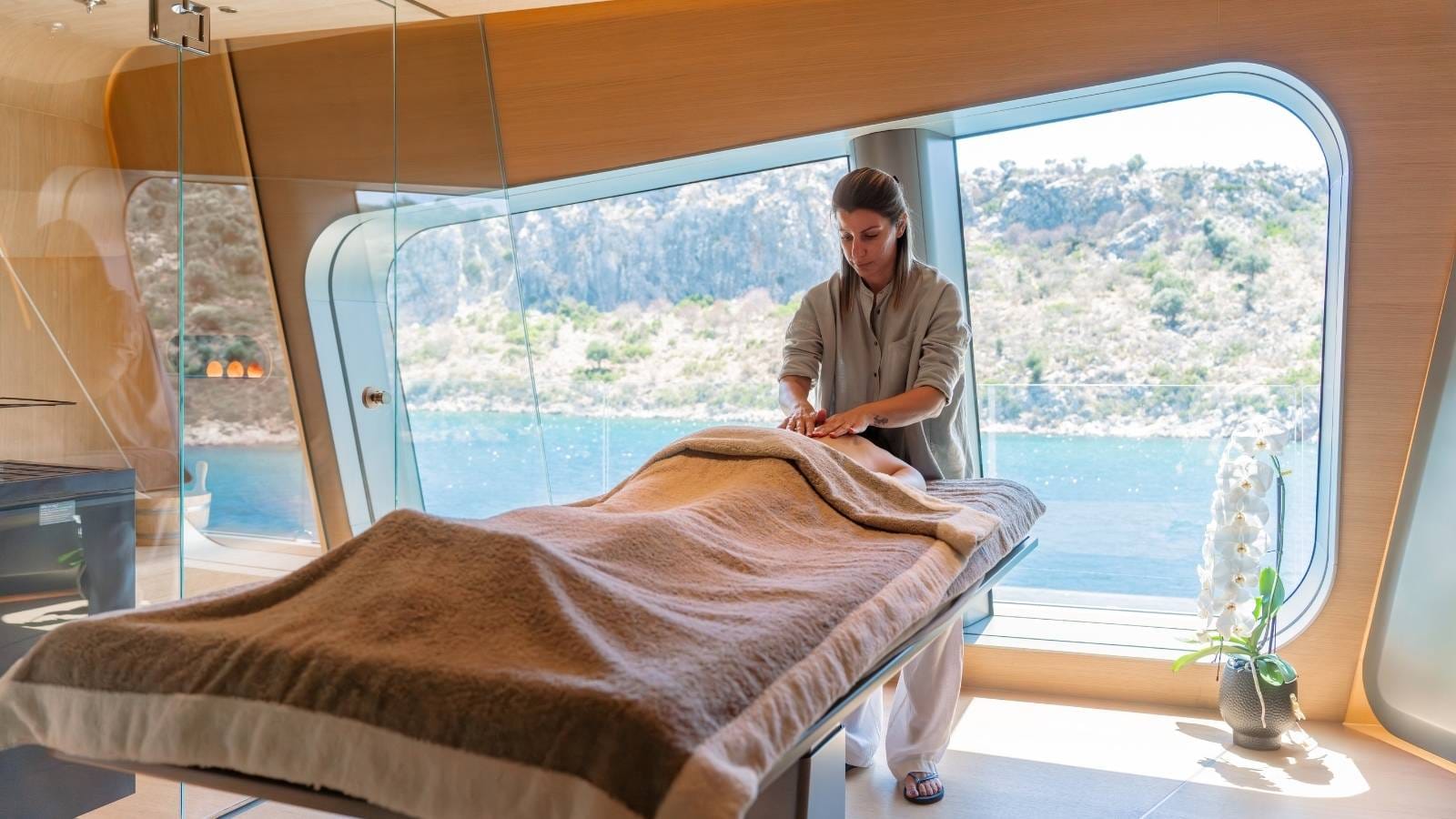 a therapist giving massage onboard the yacht this is it