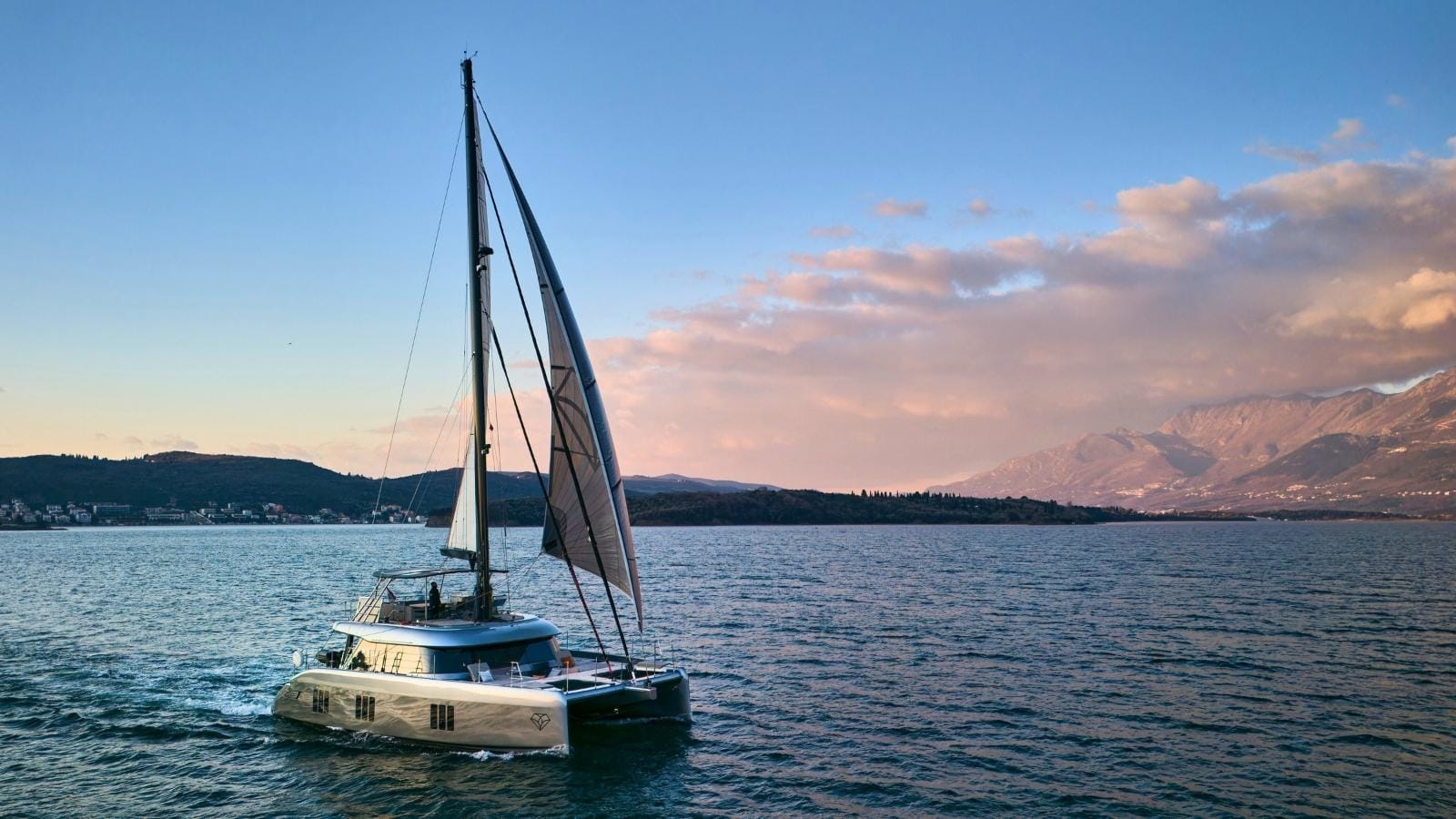 sunfreef lucy catamaran sailing during sunset