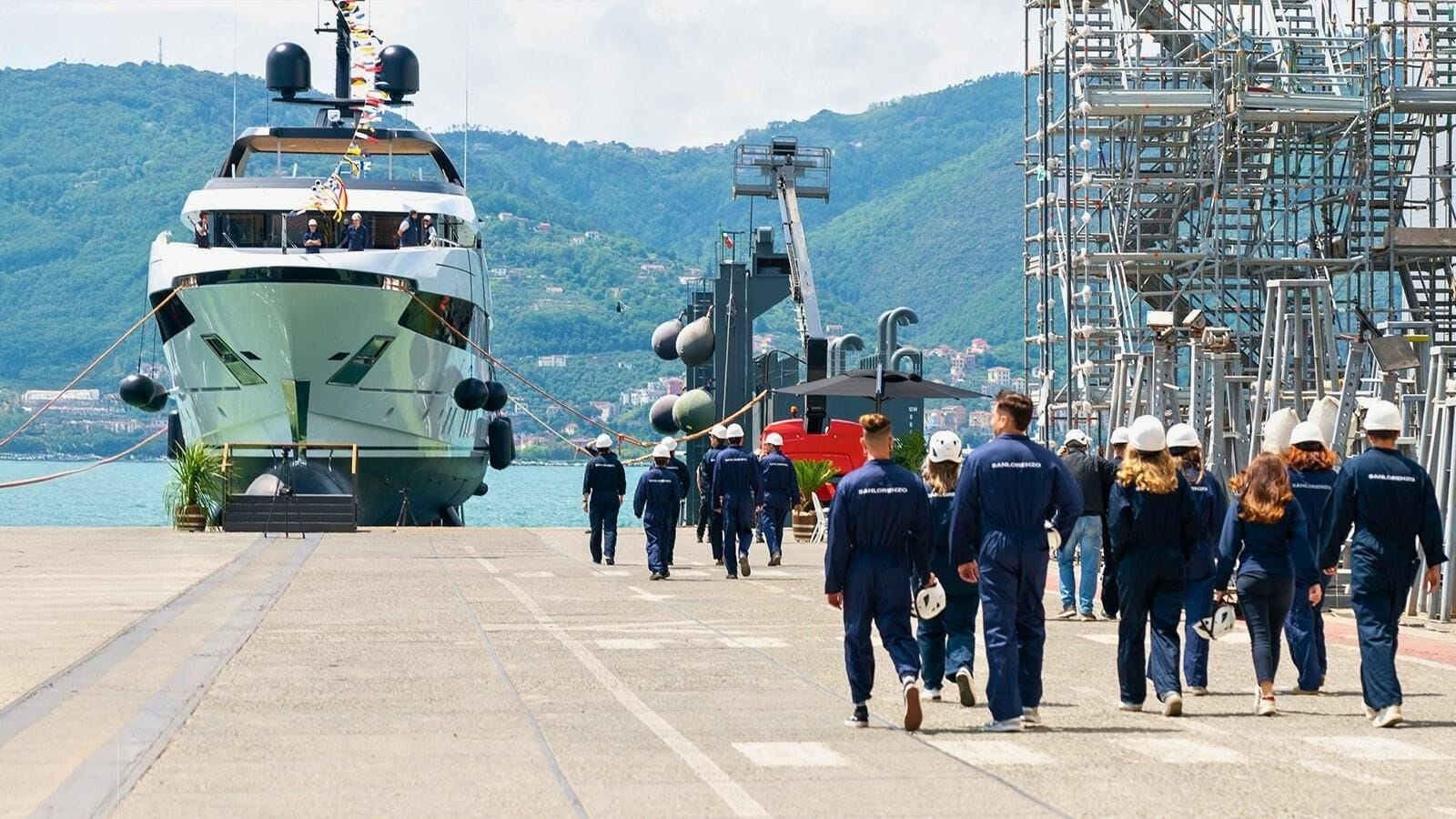 sanlorenzo employees walking towards the yacht astrea at the shipyard
