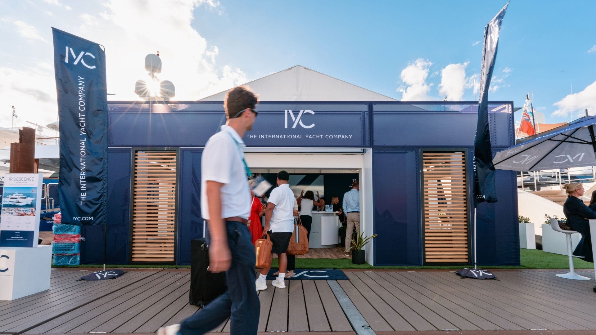 a man walking by the iyc stand in FLIBS 2025