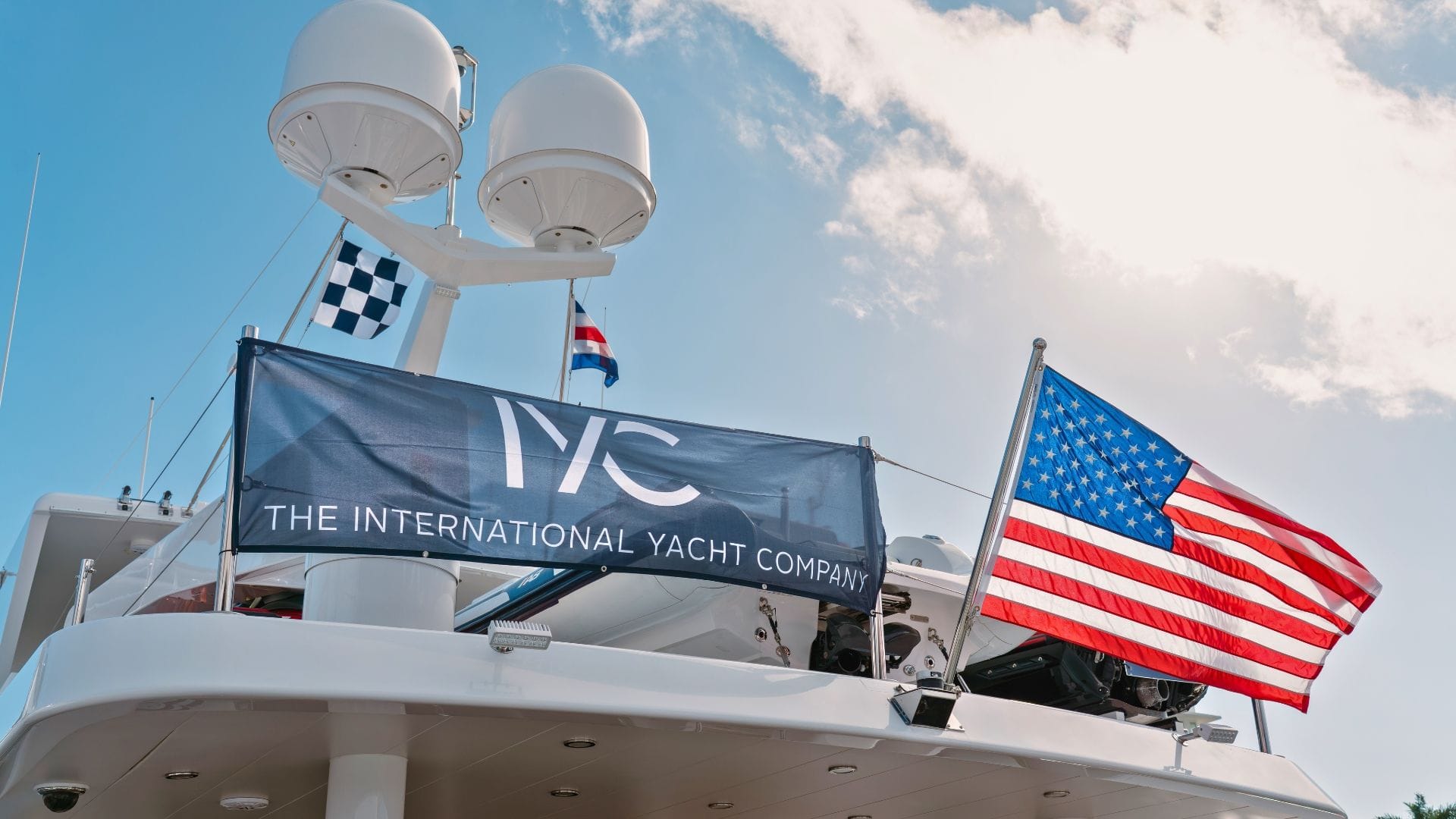 the iyc banner next to the american flag on an iyc yacht during FLIBS 2025