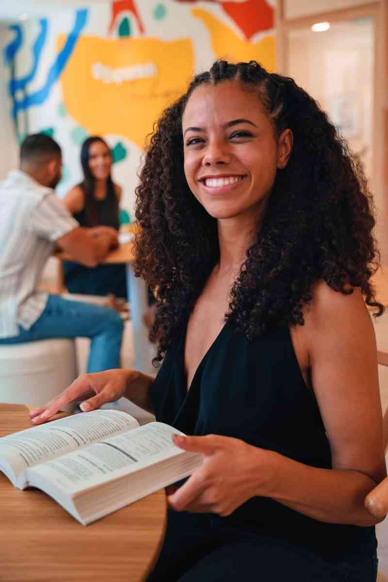 Woman practicing language skills at a cafe during travel abroad.