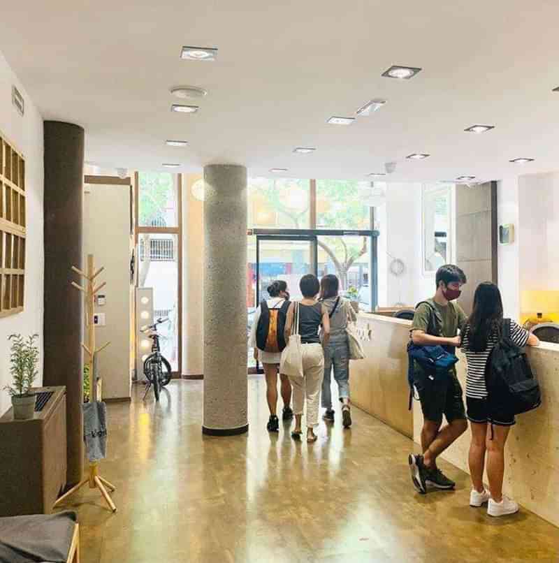 Students checking into a language school or hostel, ready for lessons.