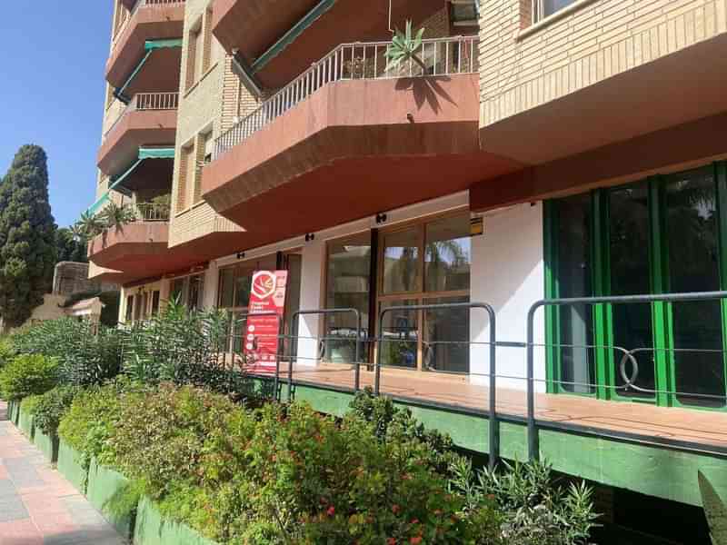 Language school building with promotion sign, encouraging language learning and travel.