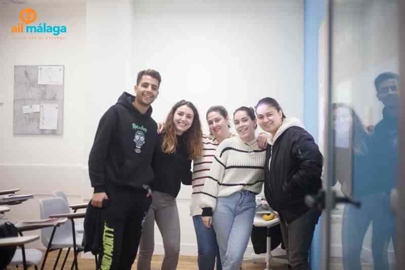 Group of students posing in a language classroom.