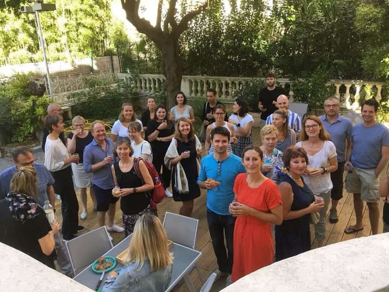 Group of people gathering for a language travel social event outdoors.