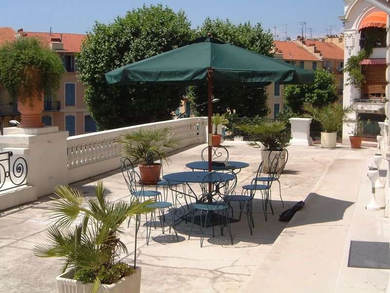 Outdoor terrace at a language school in a Mediterranean setting.