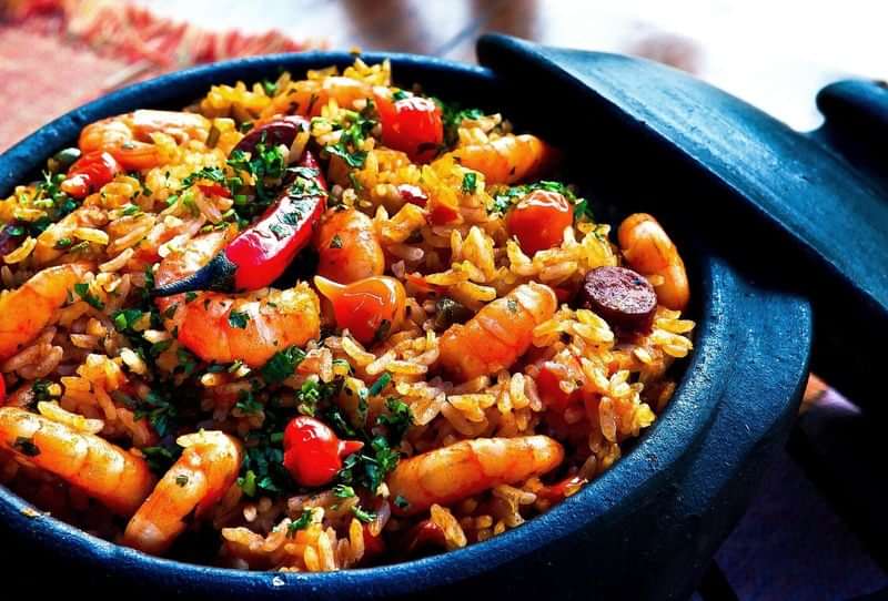 A traditional paella dish full of seafood and vibrant colors.
