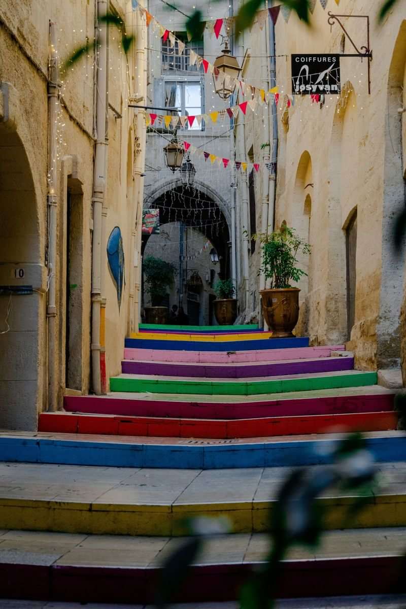 Colorful steps in charming European alley adorned with festive bunting.