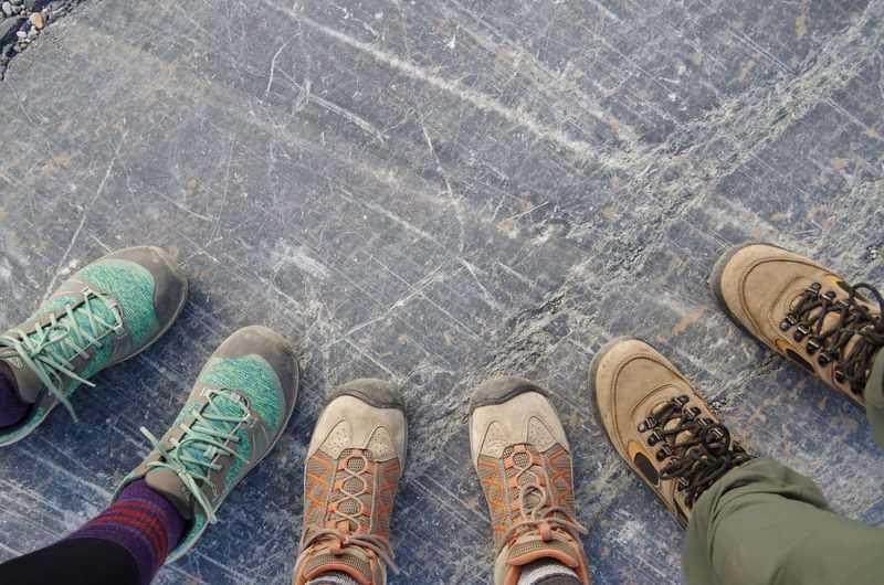 Group wearing hiking boots, exploring, capturing moments in new destinations.