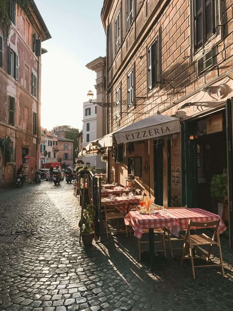 Italian street with outdoor pizzeria seating, ideal for language immersion travel.