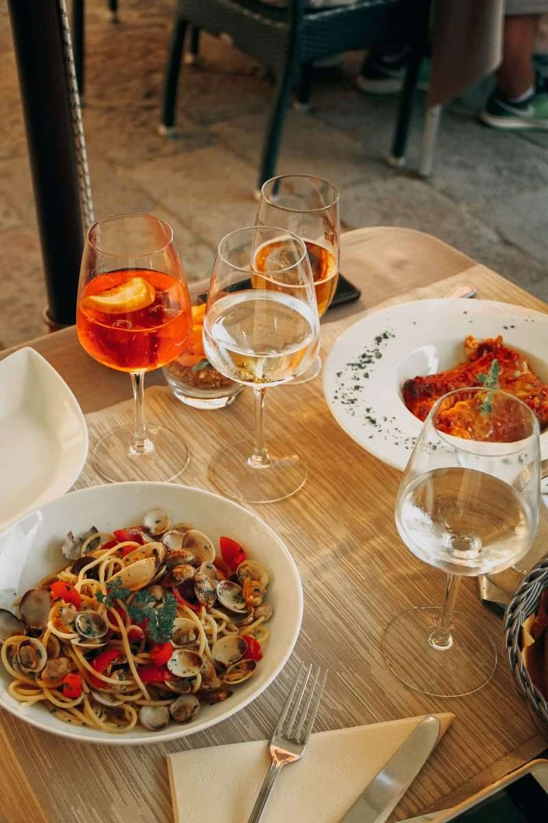 Savoring Italian cuisine: seafood pasta, risotto, and Aperol Spritz. Buon viaggio!