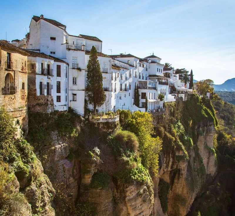 Whitewashed houses on a cliff, picturesque Spanish village, perfect for immersion.