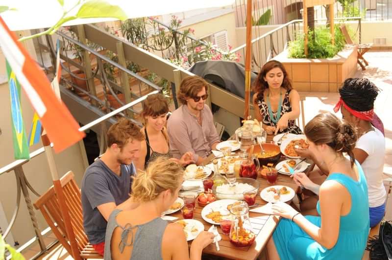 Group dining together abroad, practicing language skills over a multicultural meal.