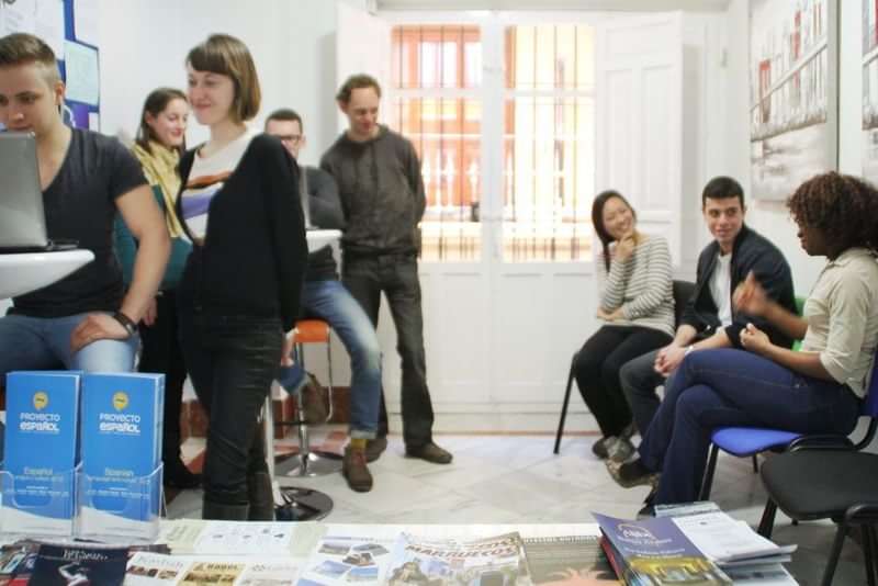 Students interacting at a language school, learning and practicing together.