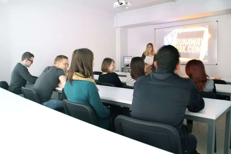 Students in a classroom attending a presentation on language travel.