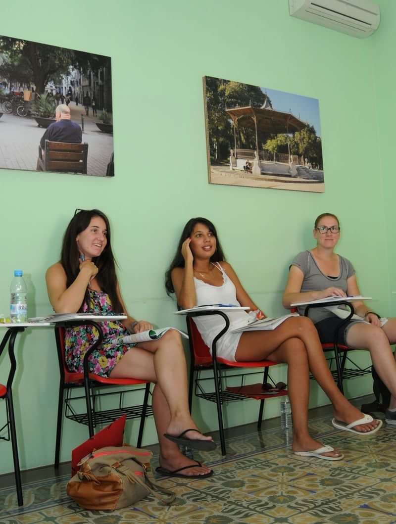 Students in a classroom, likely learning a language abroad, engaged.