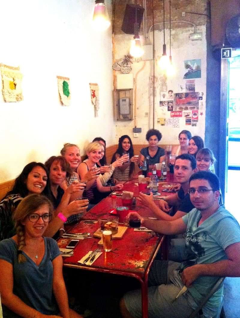 A group of language exchange students dining together, enjoying cultural immersion.