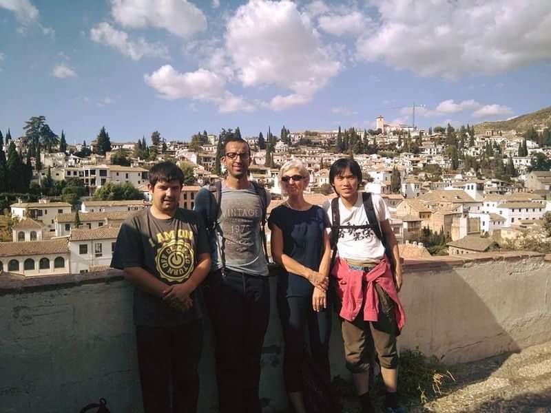 Group of friends exploring a picturesque town during language travel.