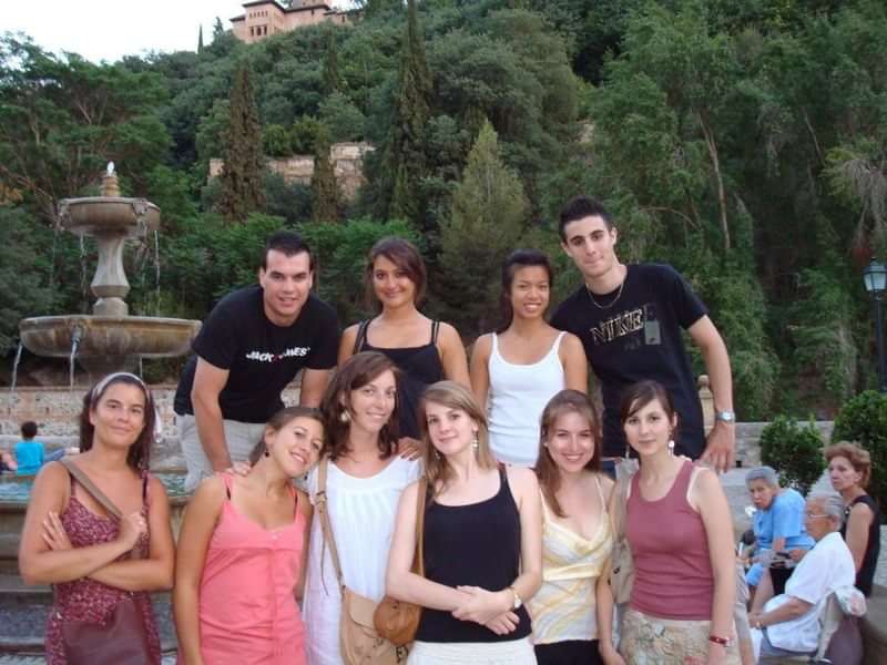 Group of young travelers posing together in a scenic outdoors location.