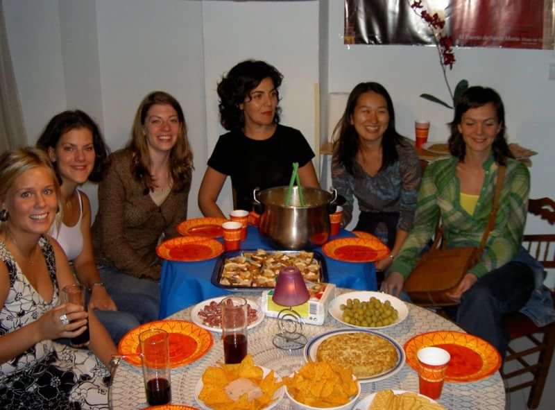 A group of friends at a multicultural dinner gathering.