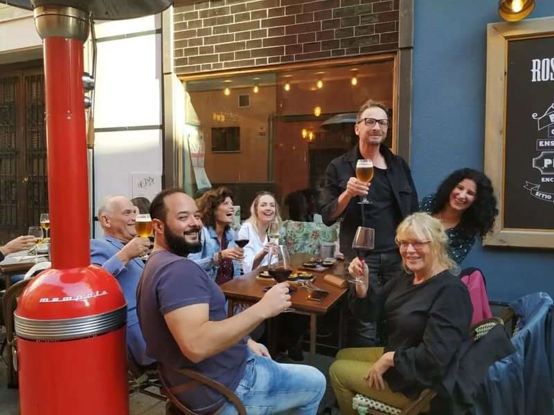 Group enjoying drinks and conversation at a local outdoor café