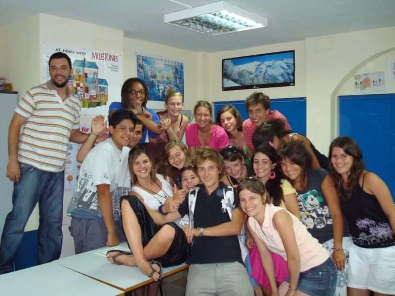 A group of students in a language travel program classroom.