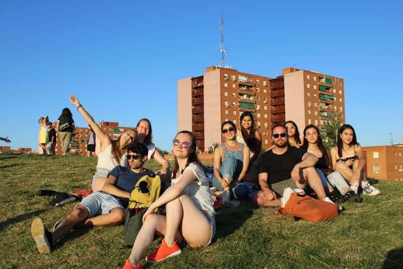 A diverse group of friends enjoying time outdoors in a foreign city.