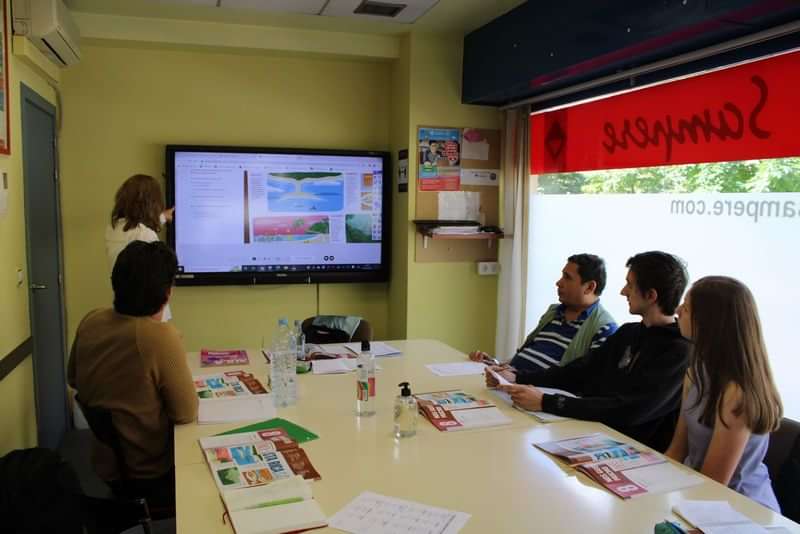 Taalreisgroep leert in klaslokaal met interactieve presentatie, locatie: Nederland.