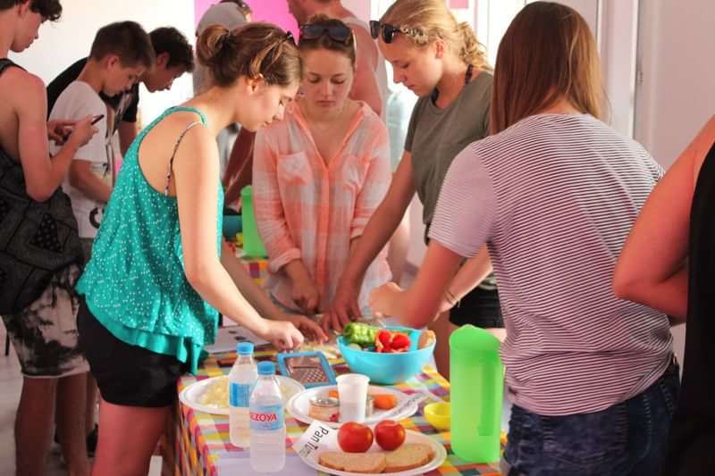 Students preparing food during a language travel cultural immersion activity.