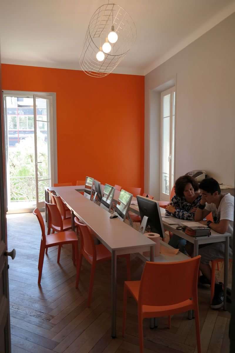 A language travel classroom setting with students and computers.