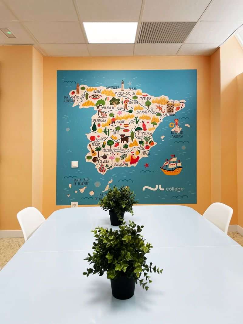 Colorful map of Spain showcasing cultural landmarks in a classroom.