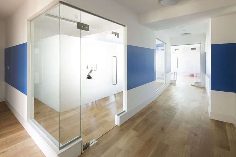 Modern language school hallway, spacious and minimalistic with wooden floors.