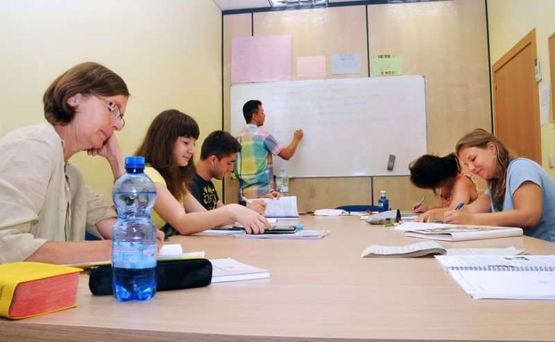 Students in a classroom learning a new language together abroad.