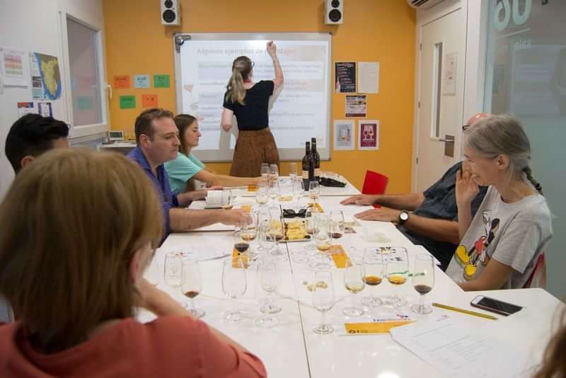 Wine tasting and language lesson in classroom setting.