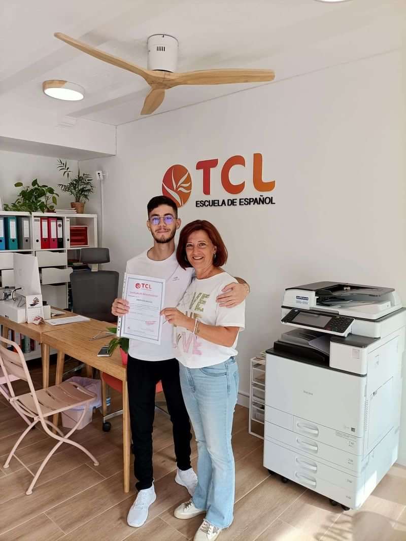 Student receiving a certificate at TCL Spanish language school.