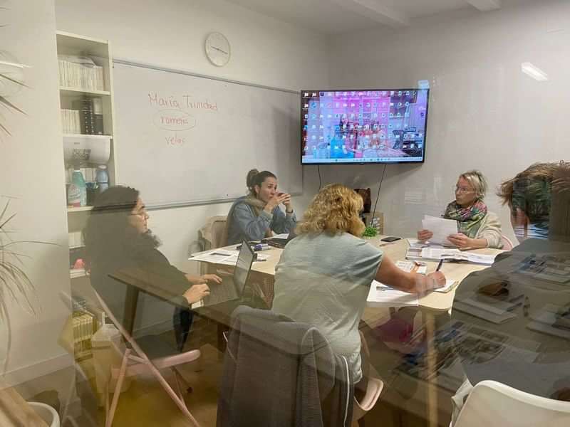 People participating in a language class meeting, learning and discussing topics.