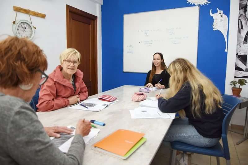 A small group of people engaged in a language learning class.