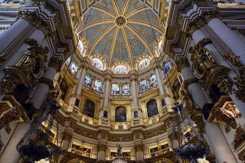 Ornate cathedral interior with stained glass windows, a popular cultural travel destination.