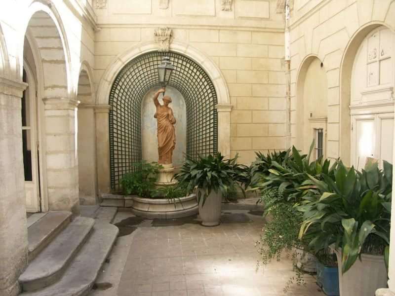 A picturesque courtyard with a statue, perfect for cultural immersion.