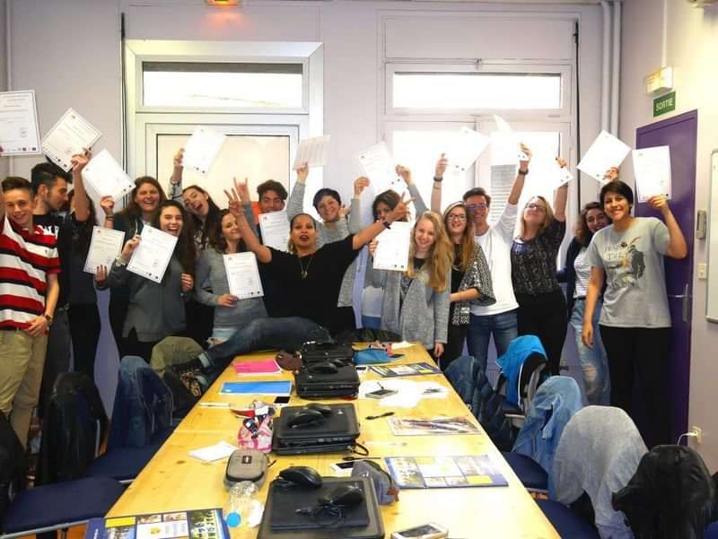Students celebrating completion of language course at a travel-based educational program.